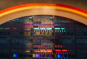 An 8-inch wafer fabricated at Sandia National Laboratories’ MESA complex for new acousto-optic device technologies. (Photo by Craig Fritz) Click on the thumbnail for a high-resolution image.
