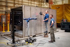 An engineer performs a 3D scan of the Mobile Vault while another verifies the results. The Mobile Vault was designed and demonstrated by a team at Sandia National Laboratories. (Photo by Craig Fritz) Click on the thumbnail for a high-resolution image.