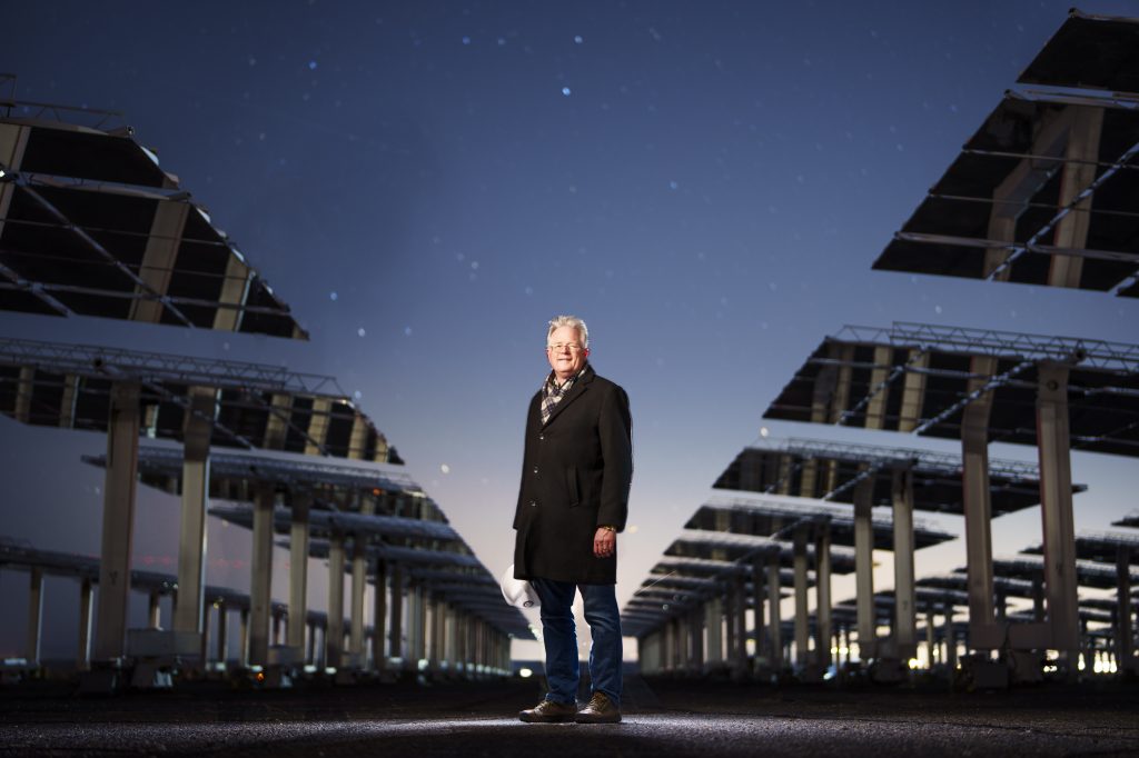John with heliostats at night