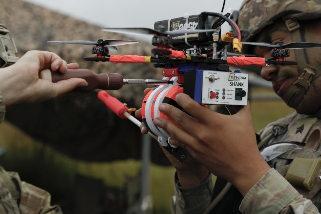 U.S. Army Sgt. Elena Killough and Sgt. Demond Blach, assigned to the Deathwatch Platoon, 10th Brigade Engineer Battalion, 1st Armored Brigade Combat Team, 3rd Infantry Division, prepare an Unmanned Aircraft System during a first person view...