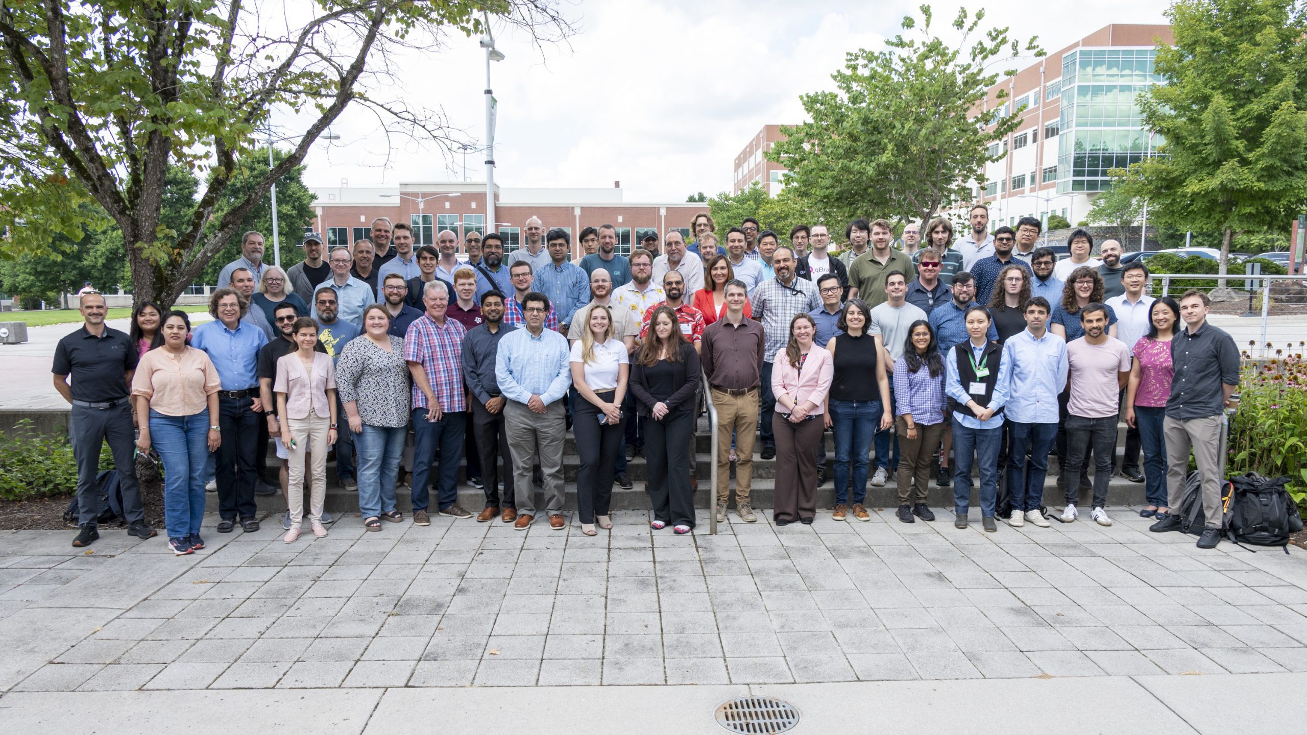 Large group photo of 75 workshop attendees outside on the ORNL main campus quad