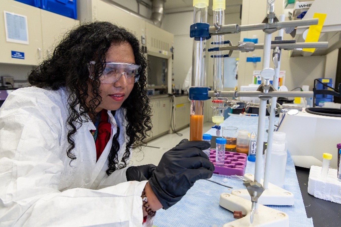 Radiochemist in the lab with coat and equipment